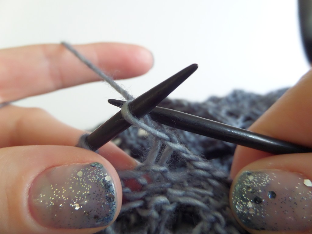 Lift the stitch on the right needle over the yarn over