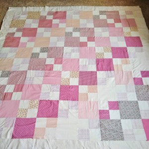 A photo of the finished quilt top showing the diagonal arrangement of 8 inch squares and 8 inch four-patch squares