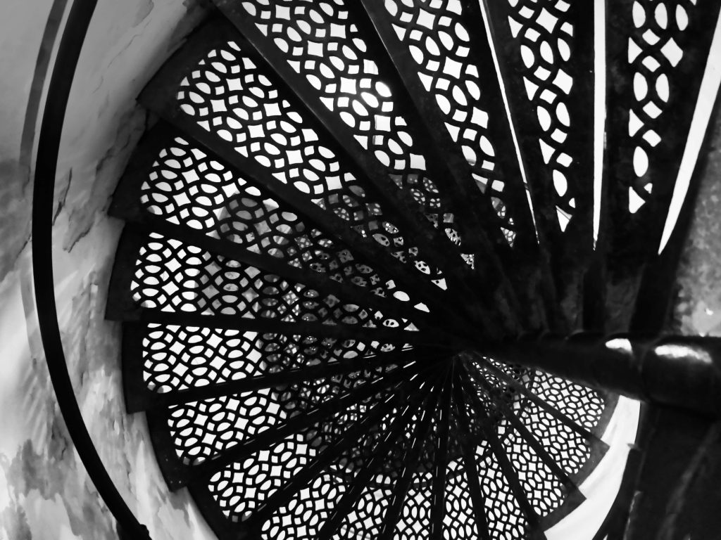 A black and white photo of a spiral staircase